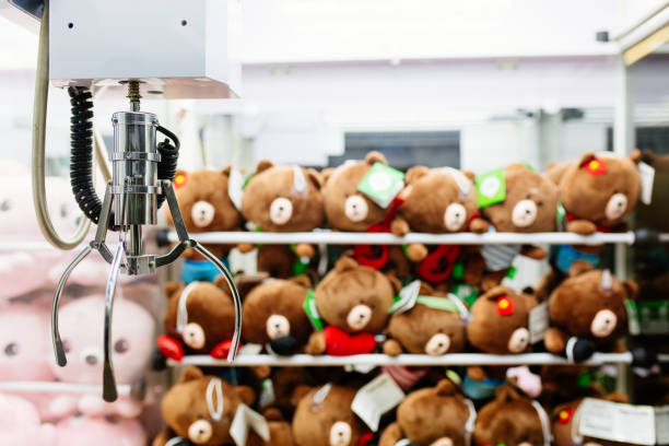 a mechanical arm selecting a random soft toy in a vending machine