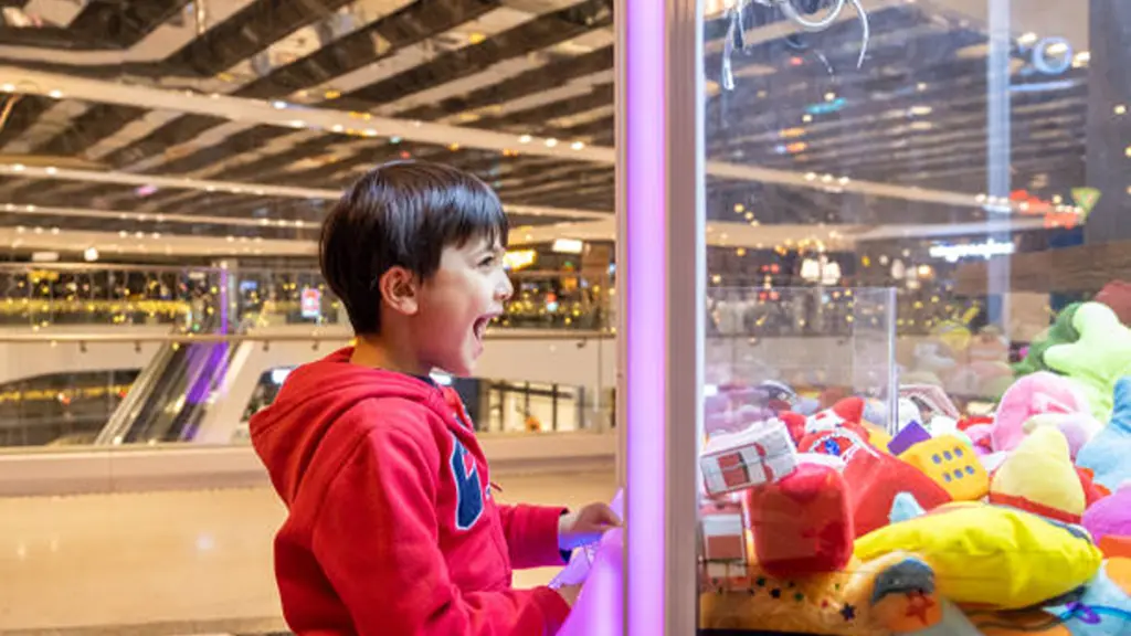 Child Playing Toy claw machine arcade