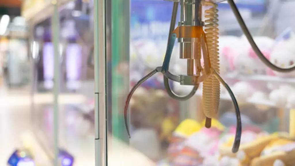 A claw machine with toy dolls
